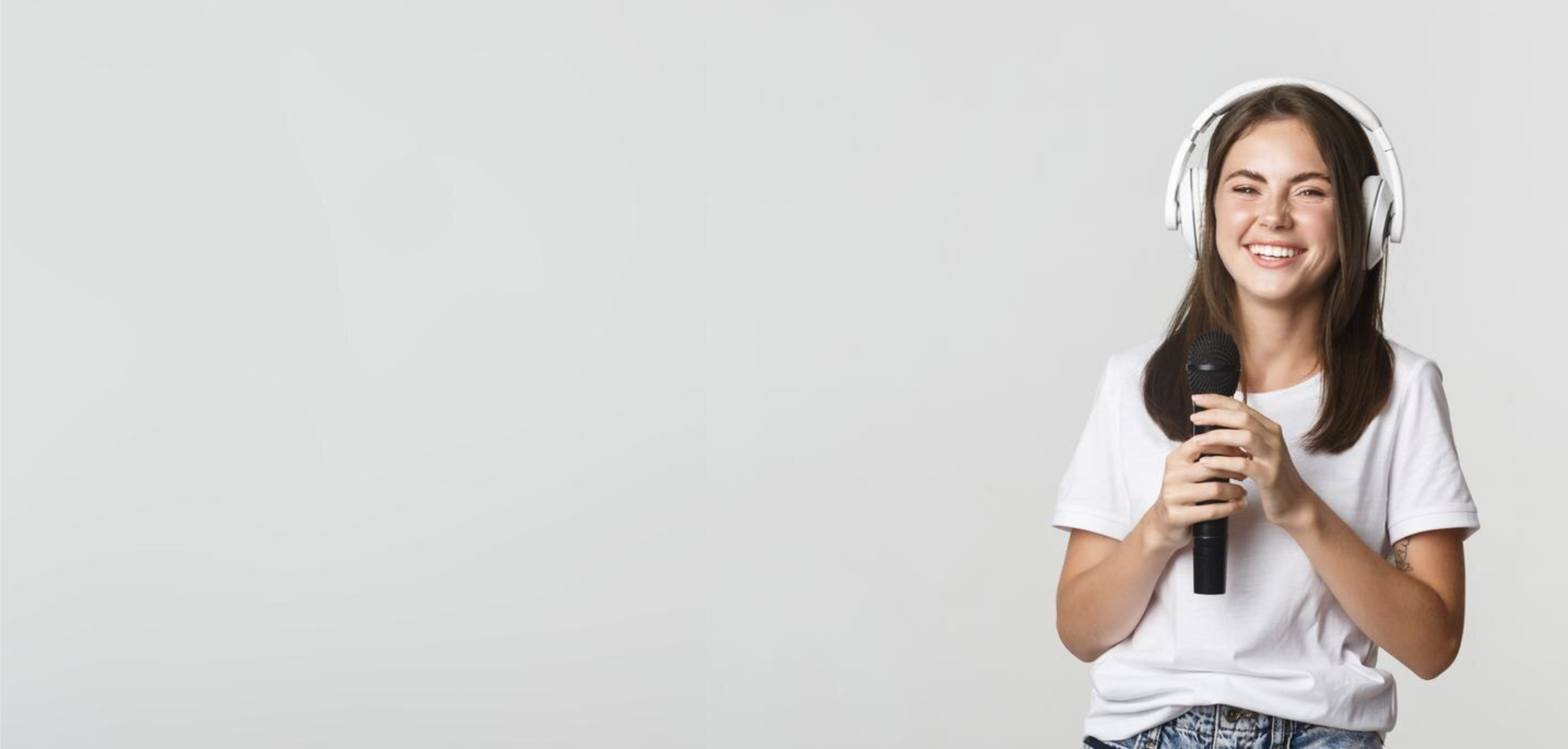 Professional woman with headphones holding a microphone — executive coach and audiobook author